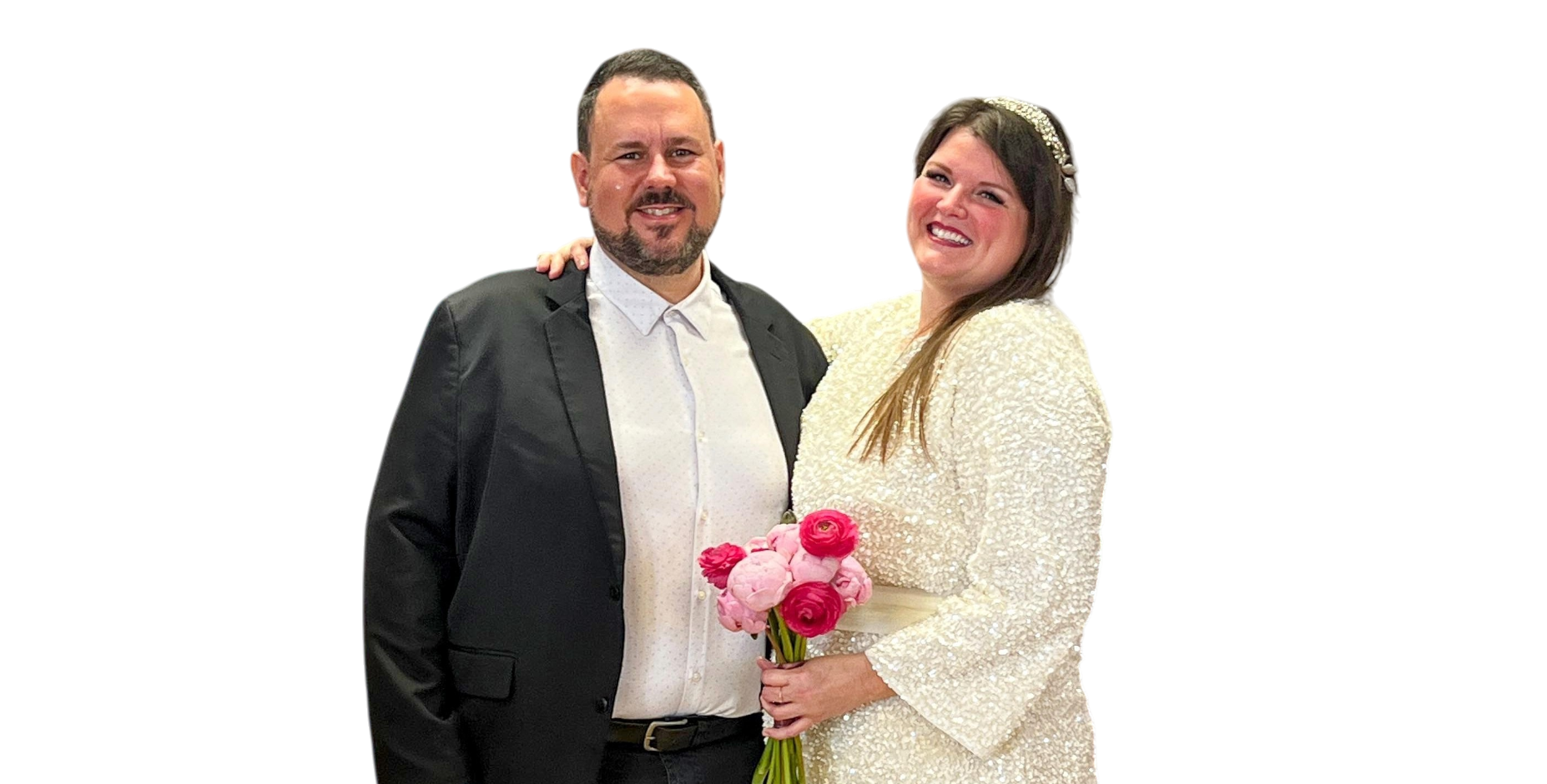A smiling couple, Anna and Biel, posing for a photo. They're both wearing wedding rings and are clearly happy.